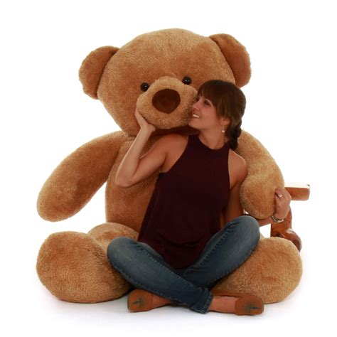 An extremely soft and huggable giant teddy bear with a heavenly plush mocha brown coat. . Life size teddy bear